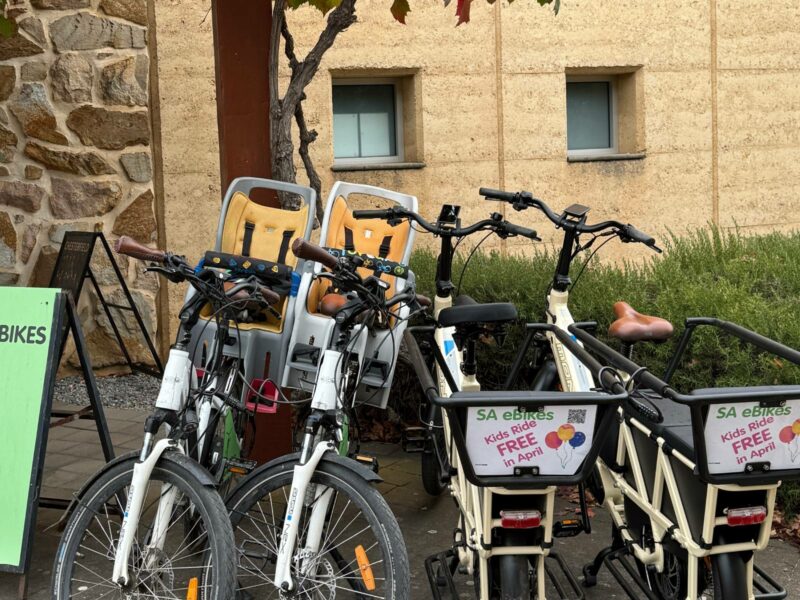 Two SA eBikes with childseats, and 2 cargo eBikes, parked at the Visitor Centre, McLaren Vale