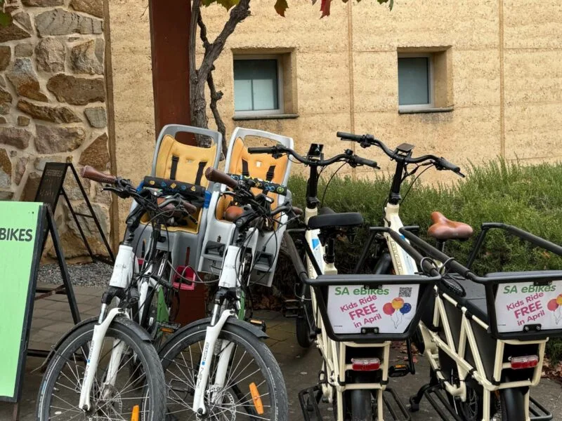 Two SA eBikes with childseats, and 2 cargo eBikes, parked at the Visitor Centre, McLaren Vale