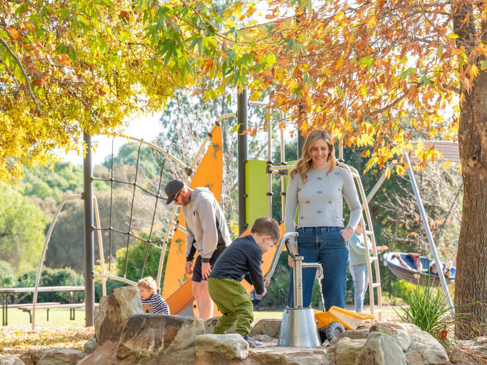 Children playing at the playground of the McLaren Vale Visitor Centre whilst thier parents watch on