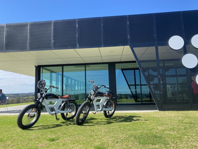 Two eBikes, styled to look like motorbikes, on the lawn beside the Vale Restaurant, McLaren Vale