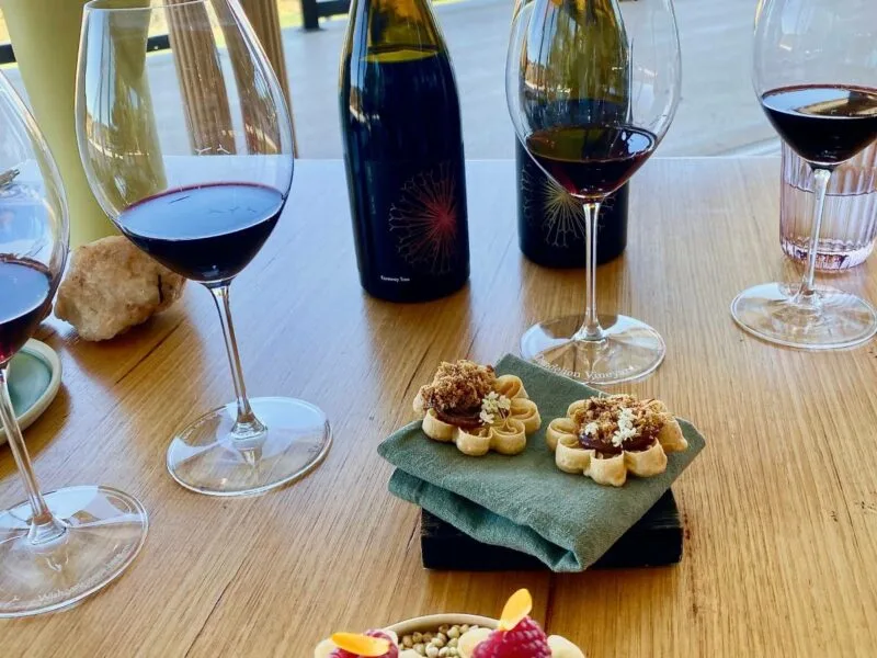 Bottles and glasses of red wine on a table at the Wonder Room, McLaren Vale