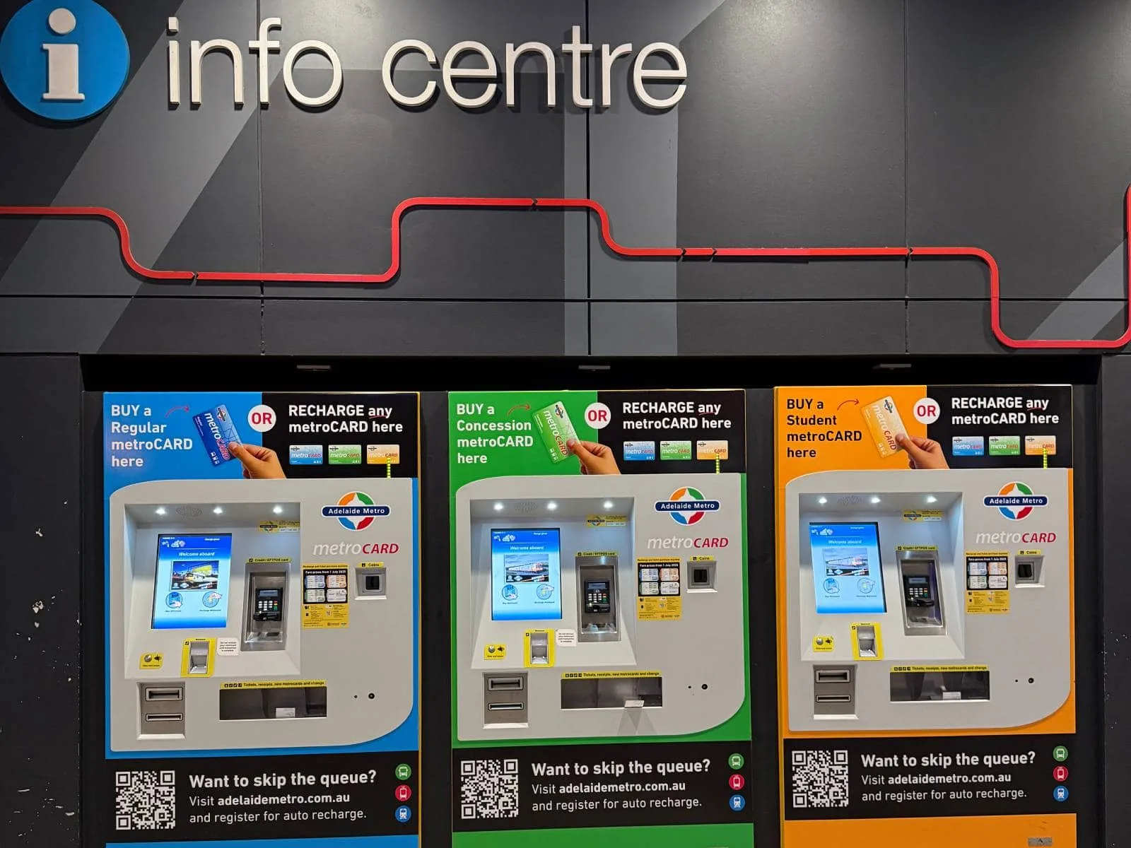 Blue , green, and orange ticket machines with the info centre logo and text above