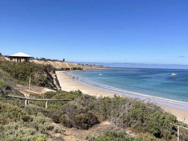 The cliffs of Port Willuuga flanking the white sandy beach and calm seas