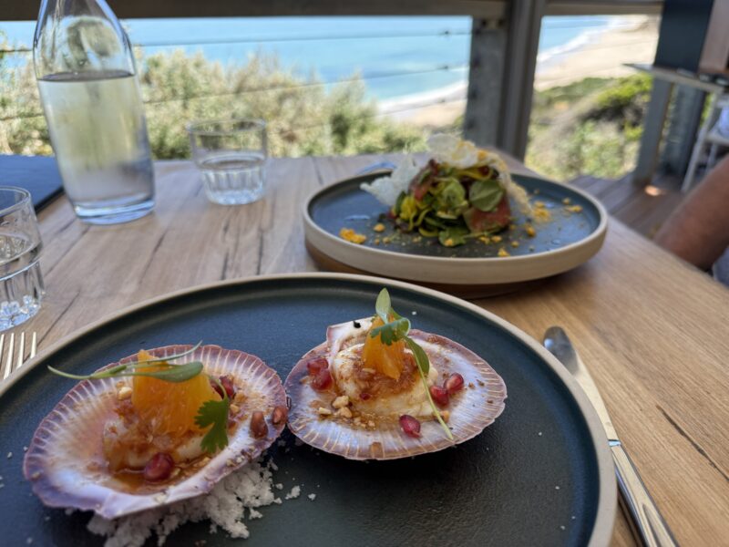 Restaurant dishes on table at Star of Greece Restaurant with sea in background