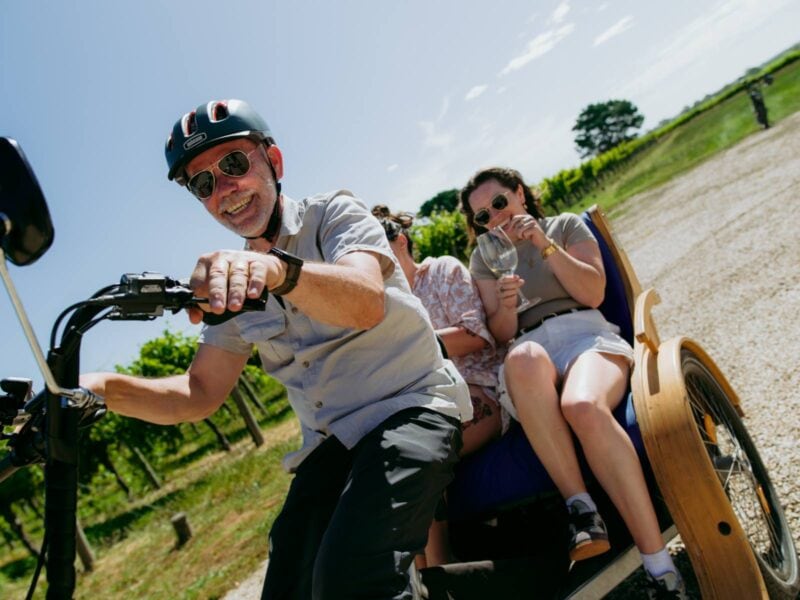 Young women laughing as the tuktuk they are riding in makes a turn