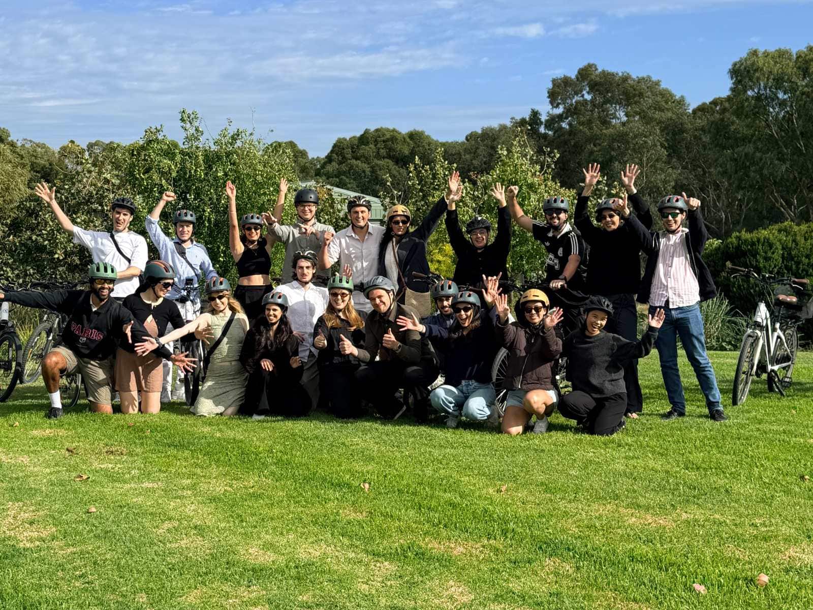 happy group of young adults with their e-bikes on the lawns of the McLaren Vale Visitor Centre
